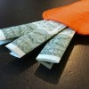 A felt pocket resembling a carrot with money poking out of the top.