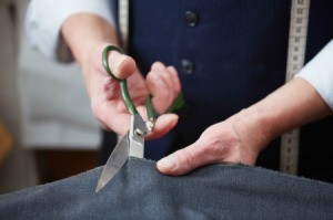 Cutting fabric with fabric scissors.