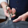 Cutting fabric with fabric scissors.
