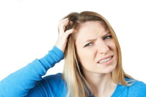 A woman itching his scalp.