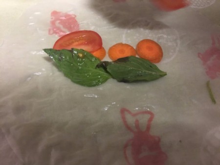 adding vegetables to center of wrap