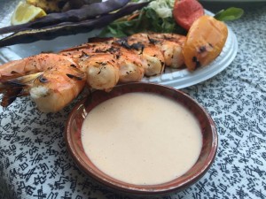Creamy Seafood Dipping Sauce in bowl with plate of shrimp