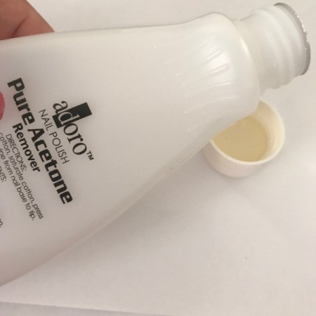 Pouring acetone into the bottlecap.