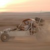 A dune buggy driving fast.