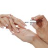 Applying nail polish to fingernails.