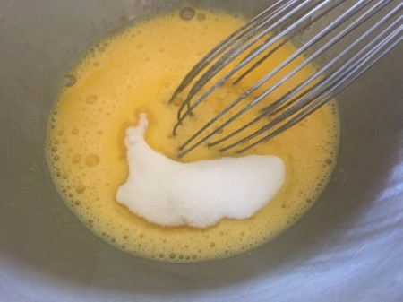 adding yogurt to eggs in bowl