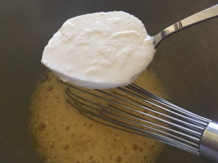 adding yogurt to egg in bowl