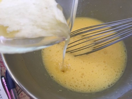adding yogurt to egg in bowl