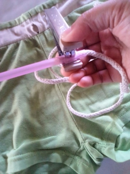 Placing a drinking straw as a channel for draw cords in clothing.