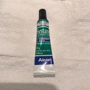 A tube of Systane eye lubricant.