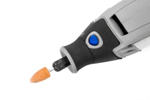 A rotary tool with an attachment.