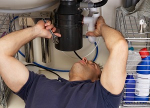 Repairing a garbage disposal.