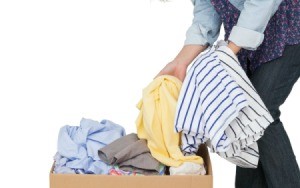 Pulling stored clothing out of a box.