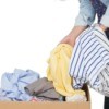 Pulling stored clothing out of a box.