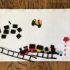 Felt Story Board - board with felt pieces, including cement truck, train cars, cargo, and track