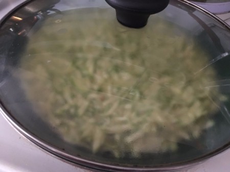 cooking frittata with cover on