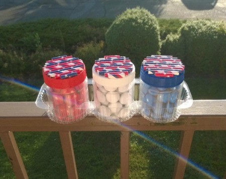 Recycled Decorative Candy Jars - finished jars sitting in a cookie tray on the balcony rail