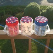Recycled Decorative Candy Jars - finished jars sitting in a cookie tray on the balcony rail