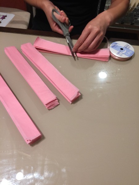 DIY Tissue Paper Pom Pom Decoration - tying ribbon knot