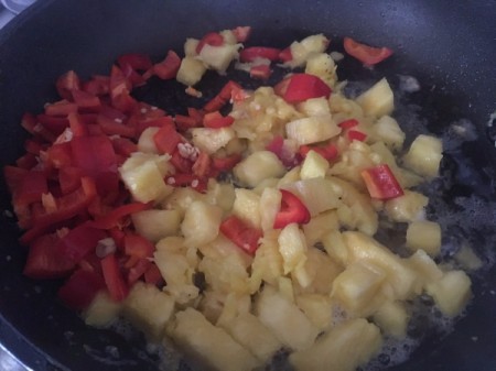 Pineapple and peppers in pan