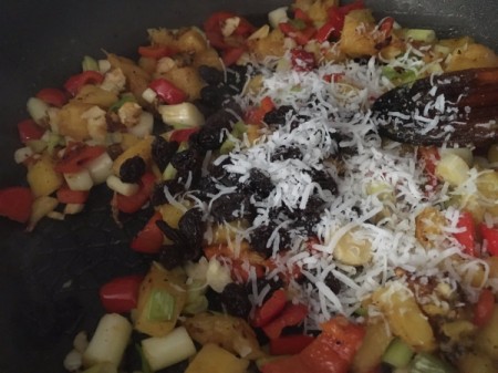 adding coconut and raisins to pan