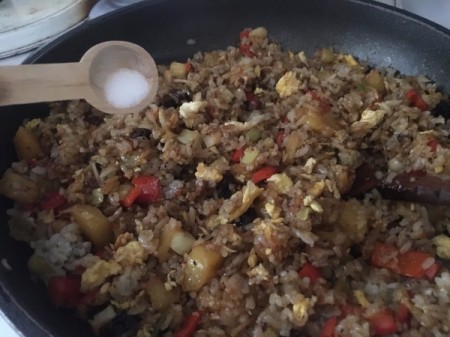 adding salt to Pineapple Fried Rice