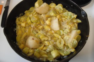 Chunks of potato added to cooked squash.