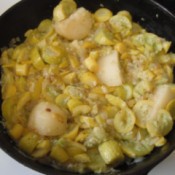 Chunks of potato added to cooked squash.