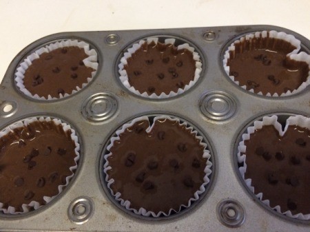 filled muffin tins with chocolate chips