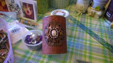 Tin Can Organizers - wood patterned paper, with brooch bent to lay against the can