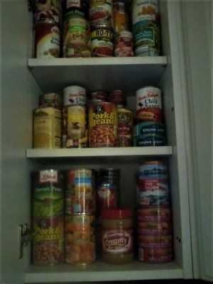 A pantry full of cans of food.