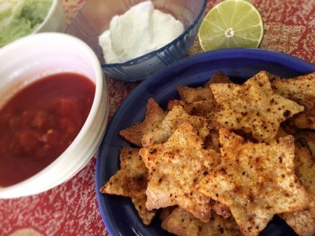 star tortilla chips in bowl with salsa and sour cream