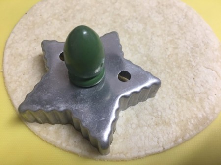 Star cookie cutter on tortilla