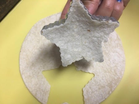 Star cookie cutter cutting tortilla