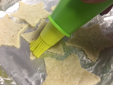 brushing lime and oil on Tortilla Chips