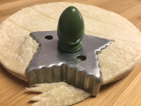 Star cookie cutter on stack of tortillas