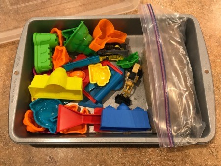 Lidded Cake Pan for Kinetic Sand - sand in a zipper bag with molds and toy machines