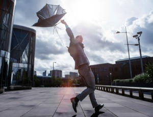 An umbrella breaking in the wind.