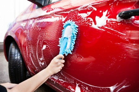 Cleaning a car door.