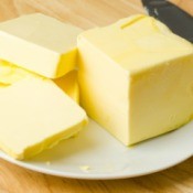 A stick of butter on a plate.