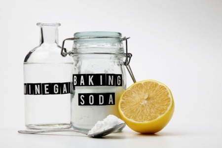 A jar of baking soda and a bottle of vinegar.