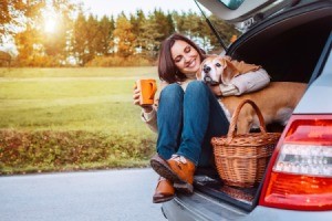 A woman and her dog on a road trip.