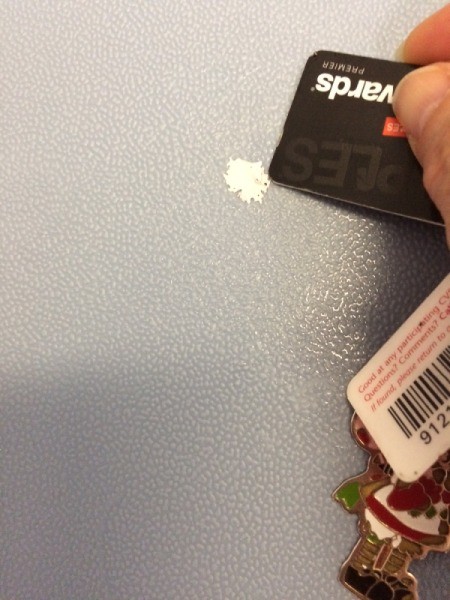 Removing Latex Paint from Hard Surfaces - pushing credit card up against the edge of the paint spot