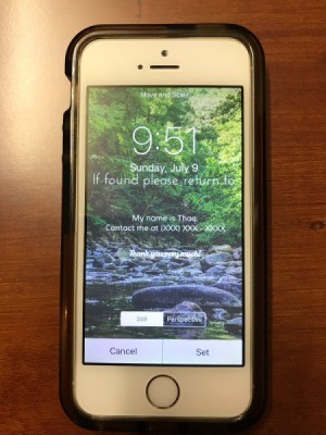 An iPhone with contact information displayed on the lock screen.
