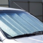 A car parked with a sun reflector in the window.