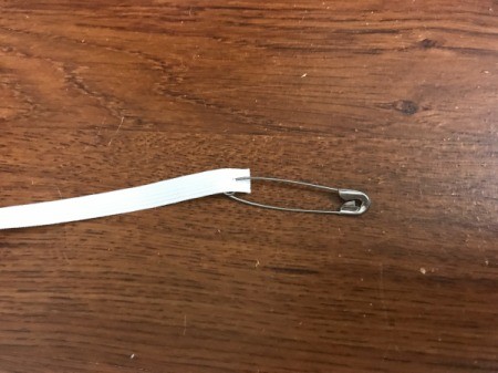 A safety pin attached to elastic.