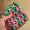 A multicolored crocheted dishcloth.
