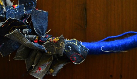 Blue Ombré Holiday Wreath - divide the hoop into 6 sections, wrap lighter blue directly about one section of strips, then on the opposite side below the strips. Repeat with the navy blue yarn.