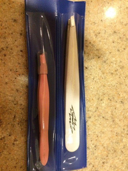 Two pairs of freshly sharpened tweezers by Tweezerman.