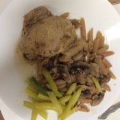 Chicken Marsala on plate with pasta and beans